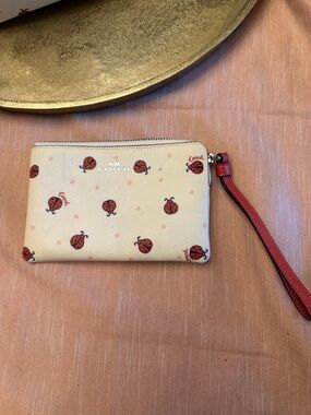 Coach Cream Je Baguette Wristlet with Red Ladybug Floral Print EUC